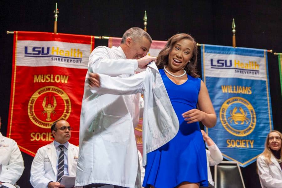 A LSU Health Shreveport medical student receives her white coat during the White Coat Ceremony A LSU Health Shreveport medical student receives her white coat during the White Coat Ceremony