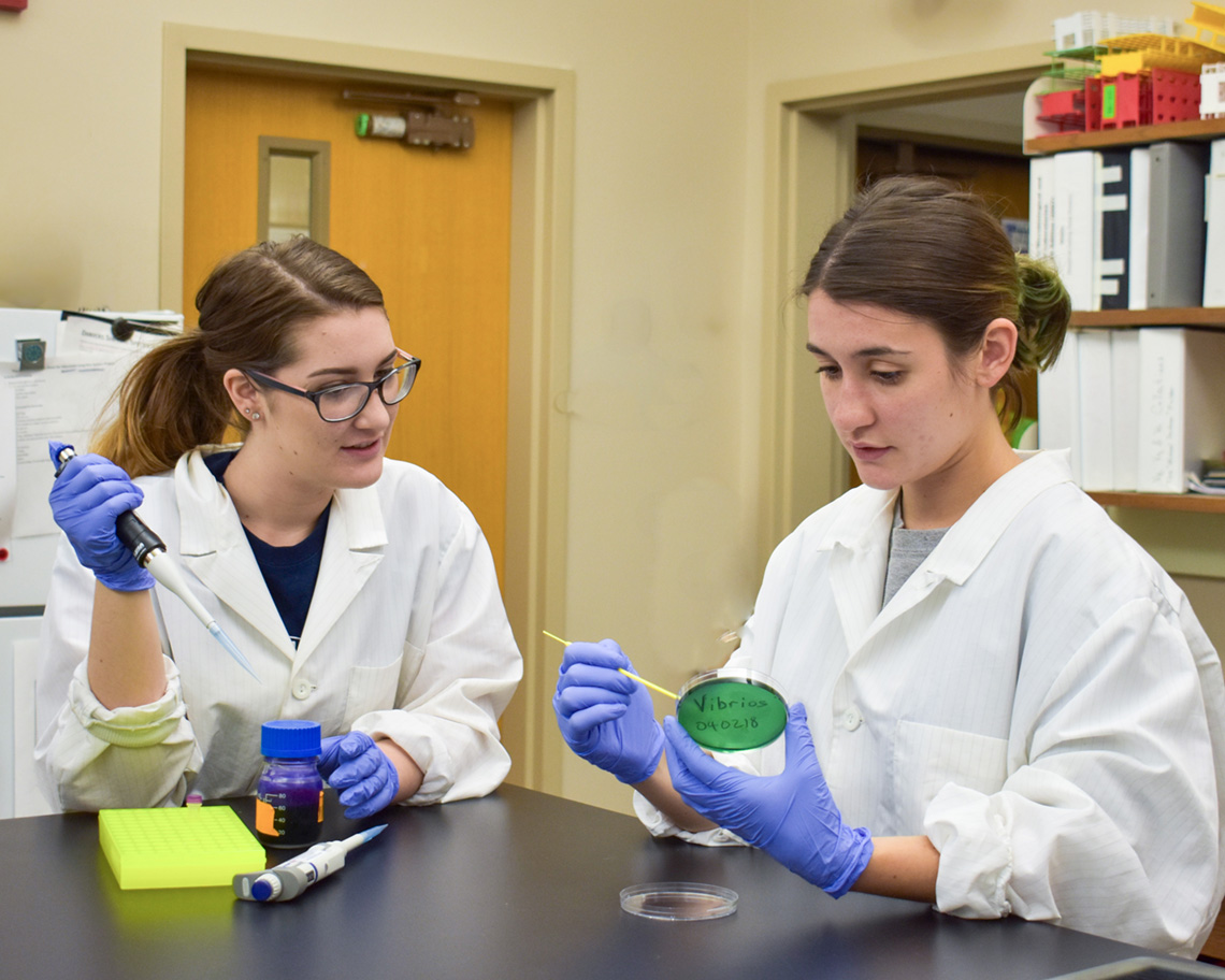 two girls with pipettes